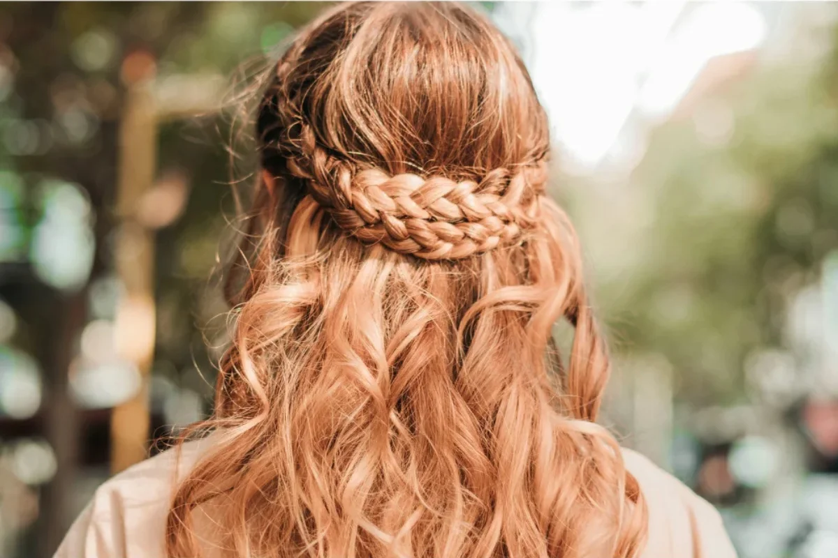 Half-up braid with loose waves on honey blonde hair