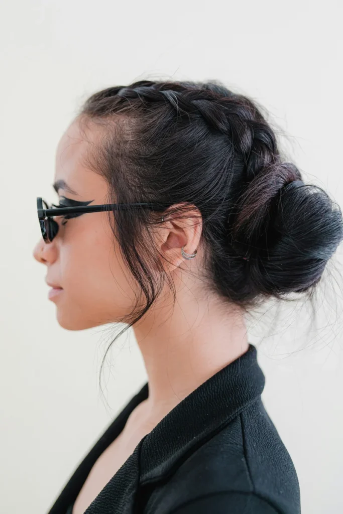 Low braided bun coiled at the nape of the neck