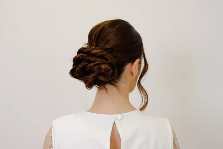 Elegant twisted low chignon updo with sparkly hair pin, back view, festive hairstyle for formal occasions