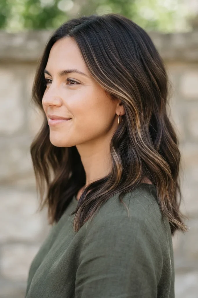 Subtle light brown highlights on dark hair, side profile