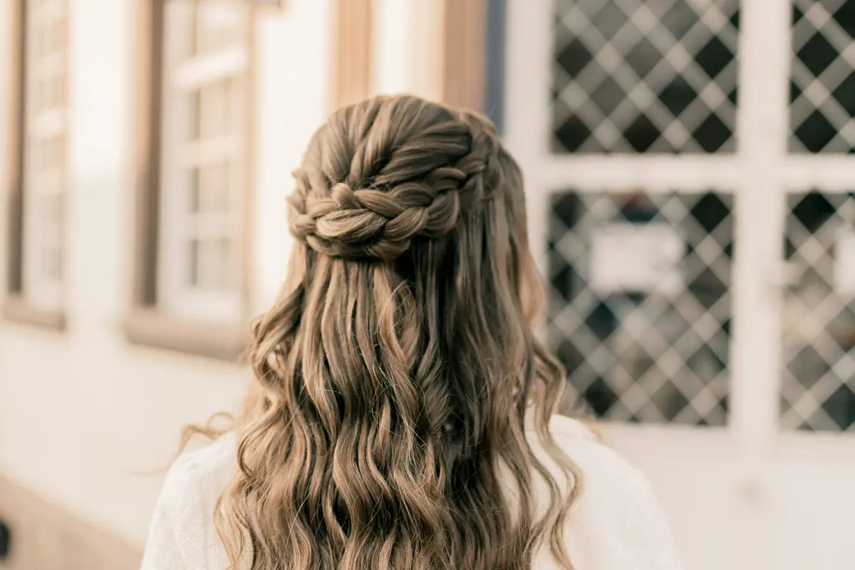 Waterfall braid crown with cascading wavy strands, outdoor natural light