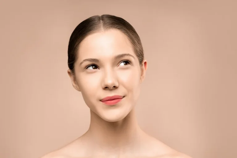 Woman with hair pulled back showing her natural face shape for a haircut guide