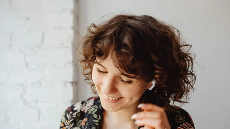 Woman with natural curly bob texture, smiling, no heat styling used
