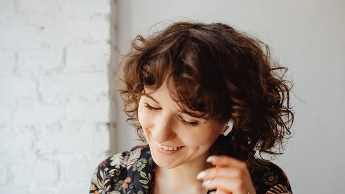 Woman with natural curly bob texture, smiling, no heat styling used