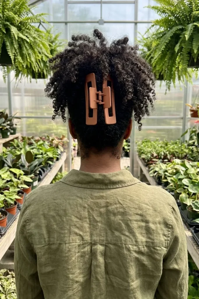 Pineapple claw clip on coily black hair with a jumbo terracotta claw clip